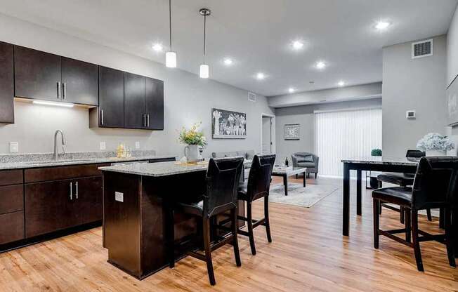 a kitchen and dining room with a table and chairs. Circle Pines, MN Lexington Lofts