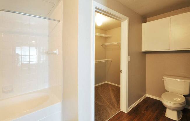 Large Soaking Tub In Master Bathroom with A Tile Surround at Stoneleigh on Cartwright Apartments, J Street Property Services, Texas, 75180