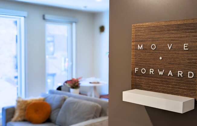 a living room with a couch and a sign that says move forward