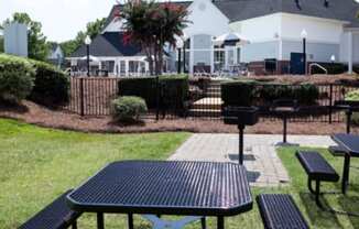 a picnic area with benches and tables in a park