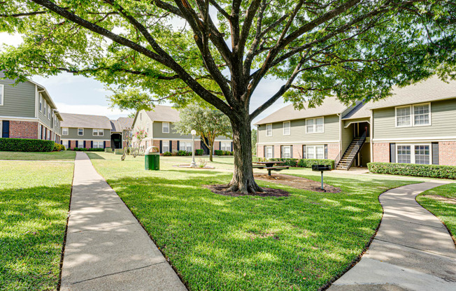 courtyard space with green grass and building exteriors  at Arbors Of Cleburne, Texas