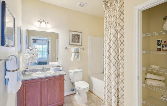 A bathroom with a toilet, sink, and shower.