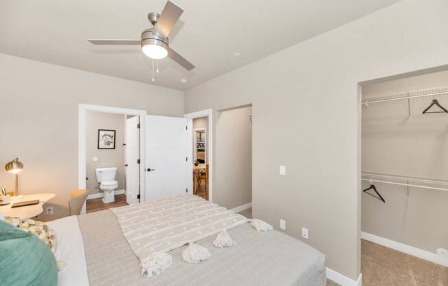 a bedroom with a large bed and a ceiling fanat Solace at Ballpark Village, Goodyear, 85338