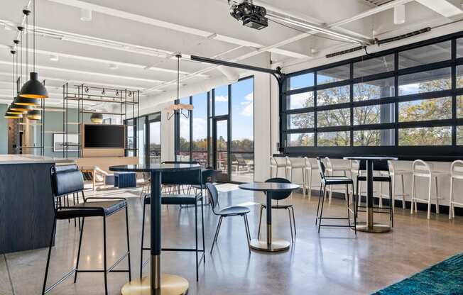 a large room with tables and chairs and a large window