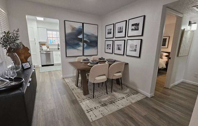 A dining room with a table set for four.