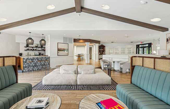 A living room with a white couch and a wooden coffee table.