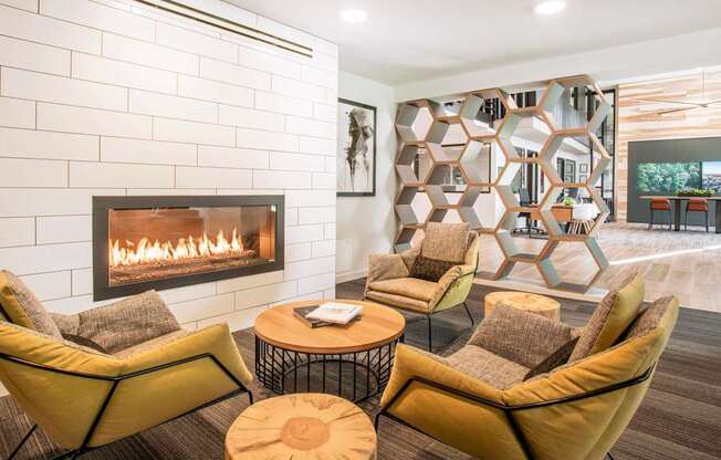 A modern living room with a fireplace and a large abstract art piece on the wall.