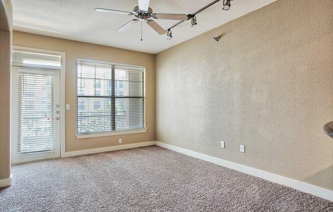 a bedroom with a ceiling fan and a window At Metropolitan Apartments in Little Rock, AR