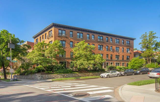 a large brick building on the corner of a street