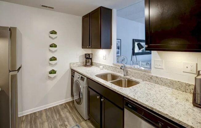 a kitchen with a sink and a washing machine