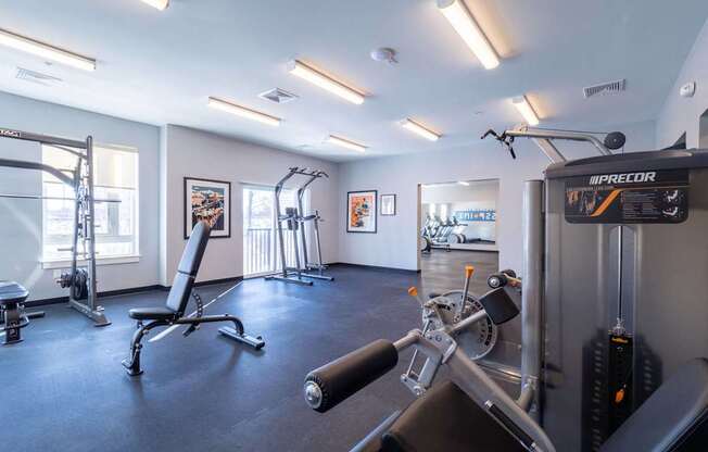 A gym with a variety of equipment including a leg press machine.