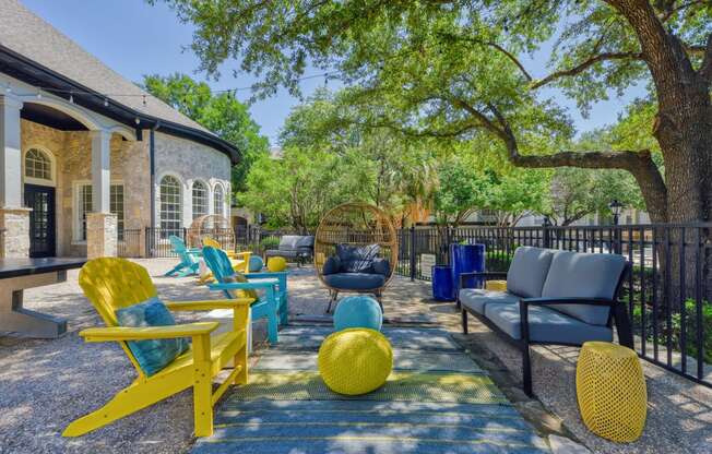 a patio with chairs and couches on a sunny day