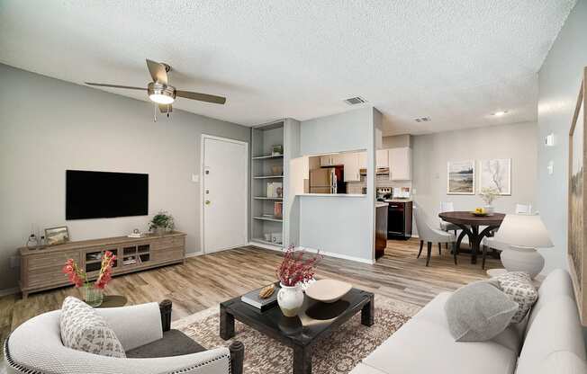our apartments offer a living room with a couch a coffee table and a flat screen tv
