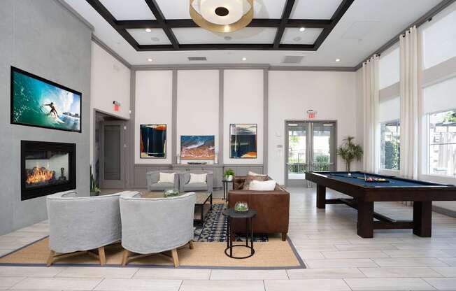 A modern living room with a fireplace and a pool table.