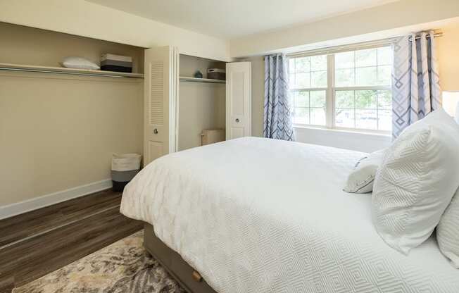 Guest bedroom with a bed and a window at Woodridge Apartments.