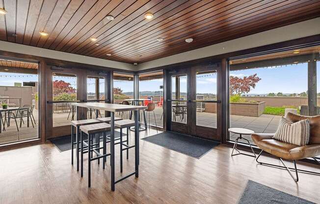 A wooden table with chairs is in a room with a wooden ceiling and floor.