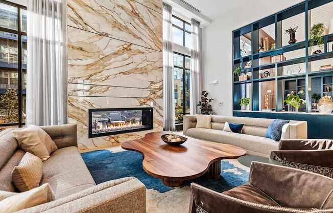 Clubhouse living room with a brown sofa and a wooden coffee table at Preston Ridge Apartments in Cary, NC.