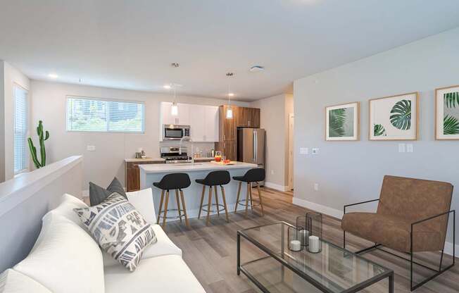 A modern living room with a white sofa and a glass coffee table.