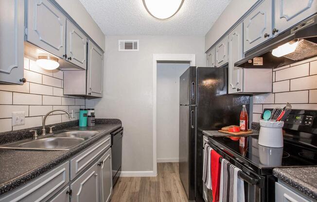 a kitchen with a sink and a refrigerator