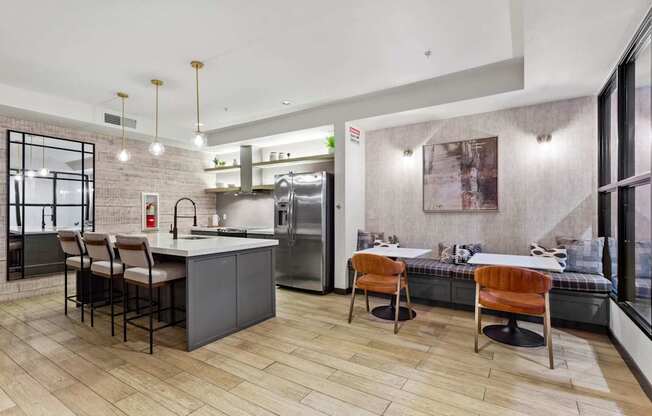 A modern kitchen with a dining area and a view of the city.