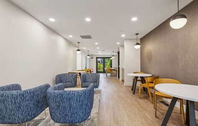 a long corridor with blue chairs and tables in a hospital lobby at Acacia Gardens, Albuquerque, NM, 87111