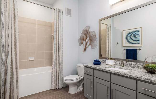 Rhythm Bathroom with Large Shower and Quartz Countertop Vanity