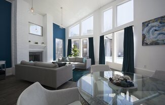 a living room with blue and white walls and a glass table