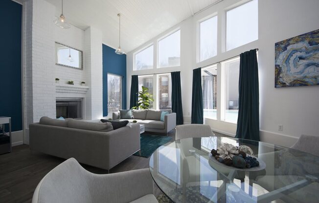 a living room with blue and white walls and a glass table