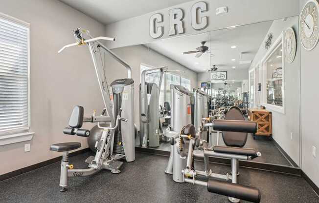 A gym with a variety of equipment including a leg press machine.