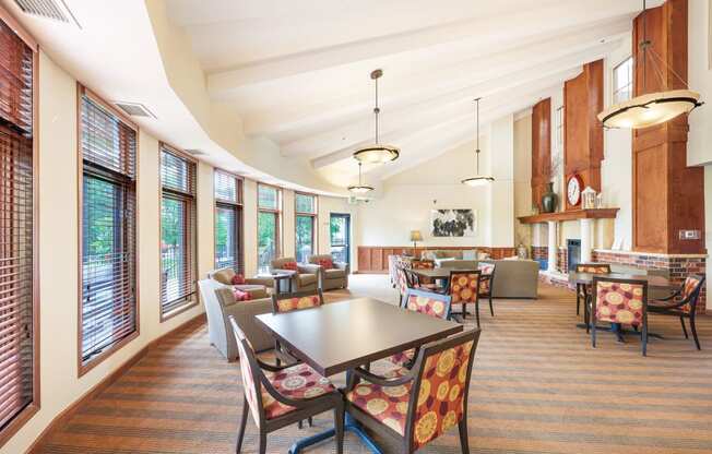 a large room with tables and chairs and windows