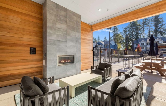 Enjoy cozy Lacey evenings  at our covered outdoor patio featuring a built-in fireplace and heater.