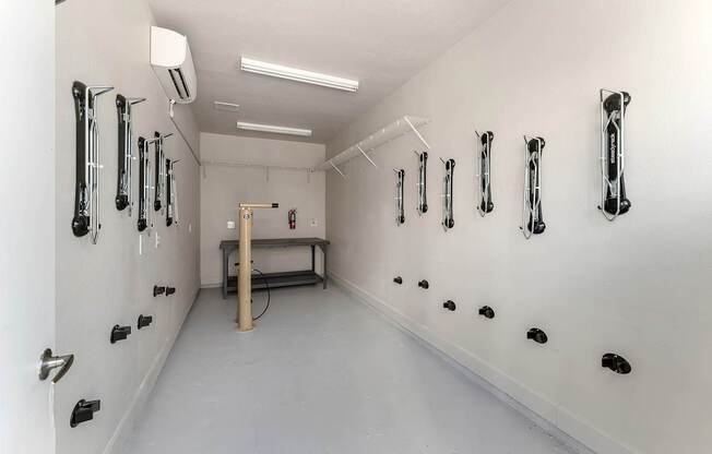 A white room with black handles on the wall.