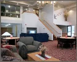 A living room with a grey couch and a wooden coffee table.