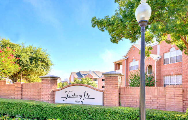 Property monument sign at the property entrance. Turnberry Isle Apartments in Dallas, TX offers 1,2 and 3 Bedroom Apartment Homes.