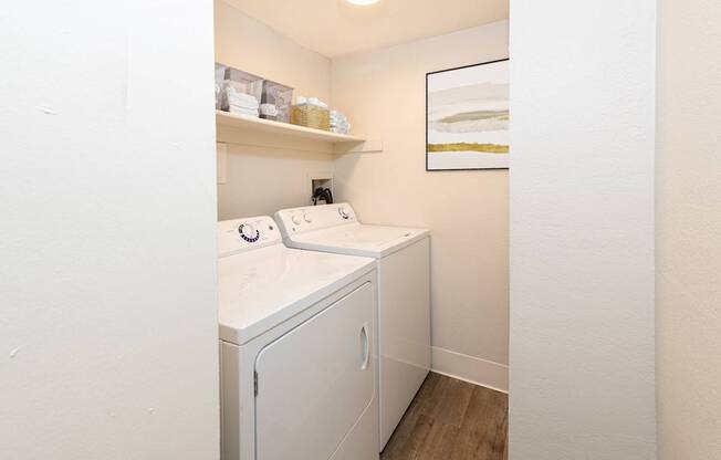 A small laundry room with a washer and dryer.