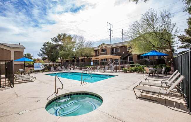A swimming pool with a slide and lounge chairs.