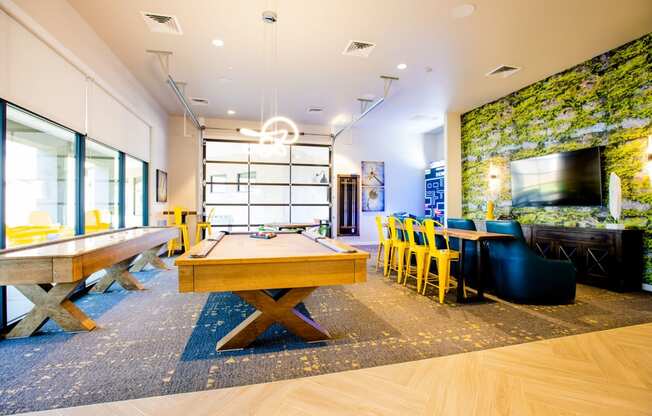 a game room with a pool table and a television