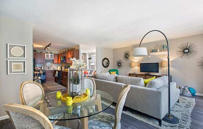 a living room with a glass table and a couch