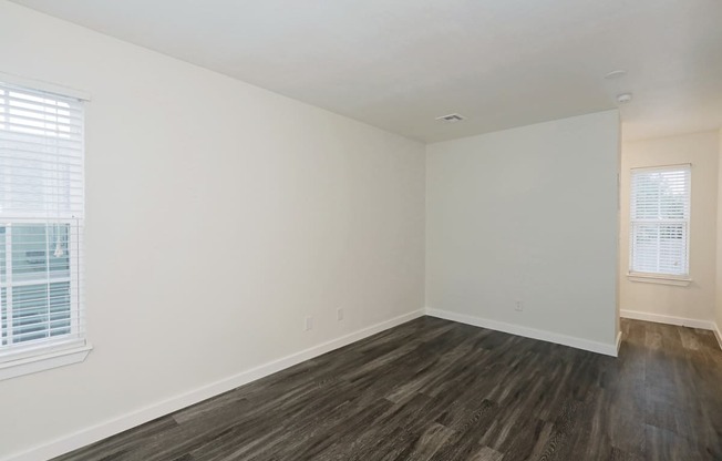 a bedroom with hardwood floors and white walls at Bennett Ridge Apartments, Oklahoma City, 73132