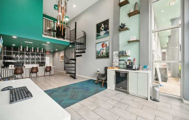 a lobby with a computer desk and a spiral staircase