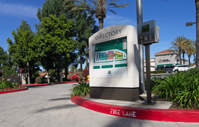 A directory sign is on a pole in front of a fire lane.