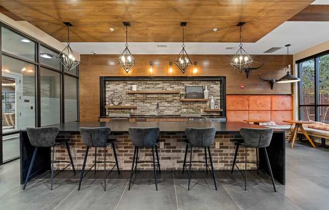 a kitchen with a bar and a brick wall