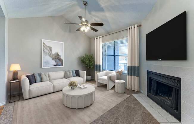 A living room with a fireplace and a television.