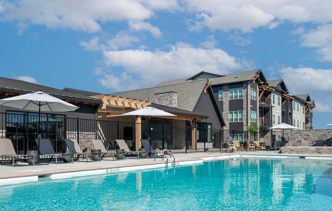 A large swimming pool in front of a resort.