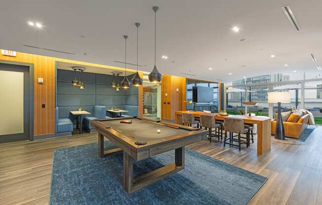 a communal area with a pool table and a dining area