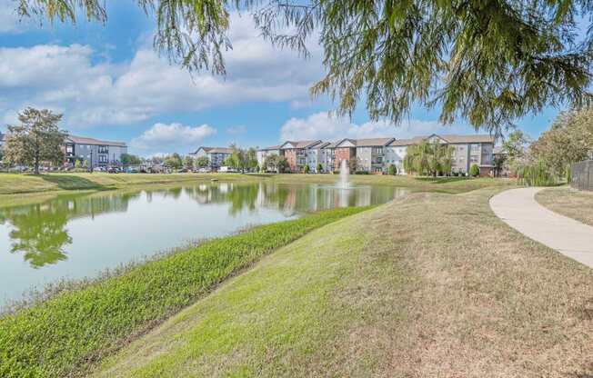 Onsite pond with apartment buildings in the background at Ultris Island Park in Shreveport, LA