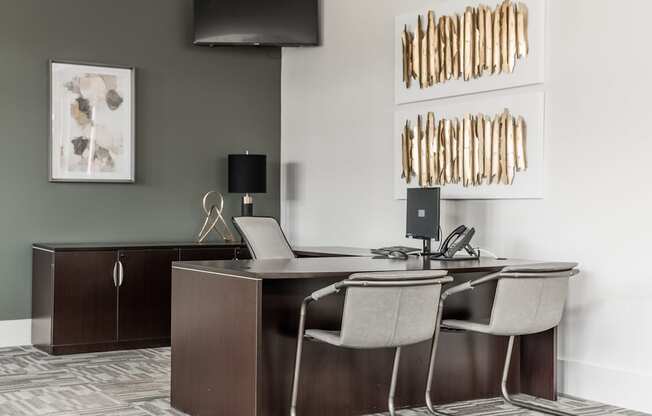 a conference room with a desk and chairs and a television