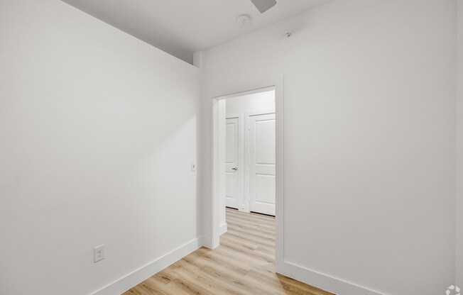 A white hallway with a door at the end. at Aurora Watson Branch, Texas, 76063