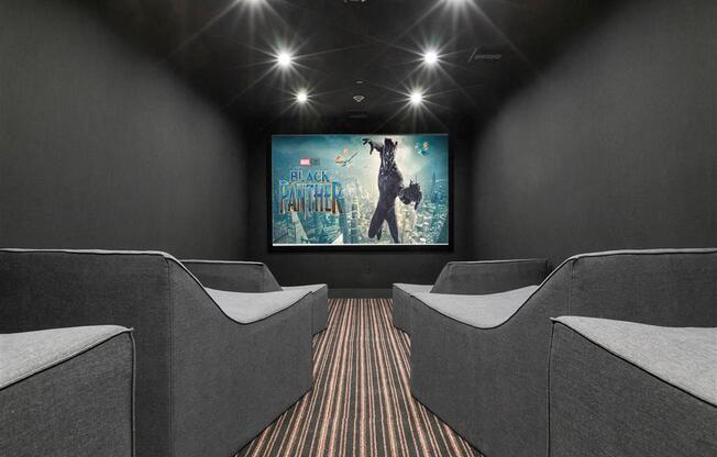 a home theater with couches and a screen on the wall