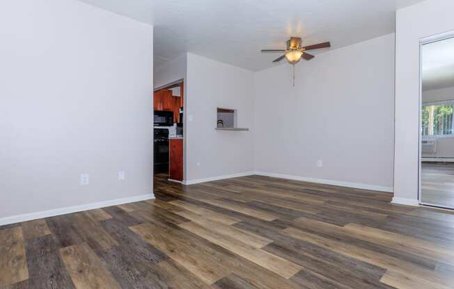 a living room with hardwood floors and a ceiling fan